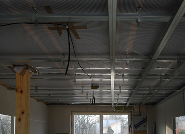 The grid is ready for hanging gipsun ceiling, vapor barrier is continuously under the rafters