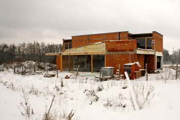 Celkový zimní pohled na dům s okny ze sousedního pozemku (jižní strana).
