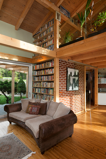 Living area - sofa by the fireplace surrounded by built-in libraries