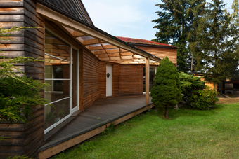 Roofed entrance and living terrace connects the interior of the house with large garden