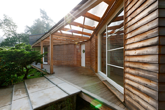 Roofed entrance and living terrace connects the interior of the house with large garden