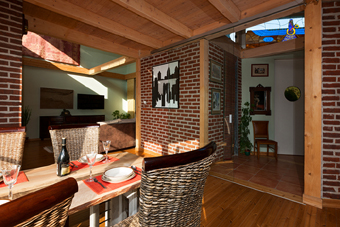 Living area - dining room connected to the kitchen, above the entrance to the house is stained glass with the Persian god Myrtha