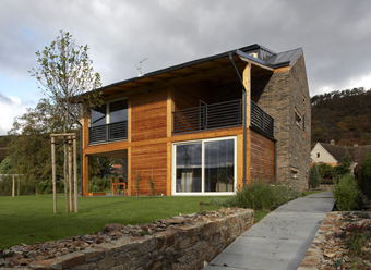 The facade is a combination of face bricks and wooden paneling